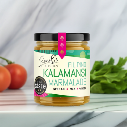 RoniBs Kitchen Filipino Kalamansi Marmalade with Don Papa Rum in a jar, showcasing vibrant orange marmalade with a spoon.