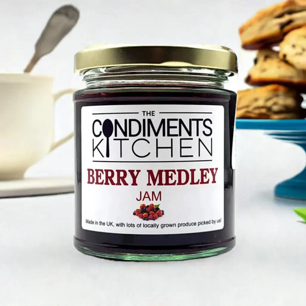 Jar of Berry Medley Jam by The Condiments Kitchen with mixed berry chunks and vibrant fruit colors in a glass jar