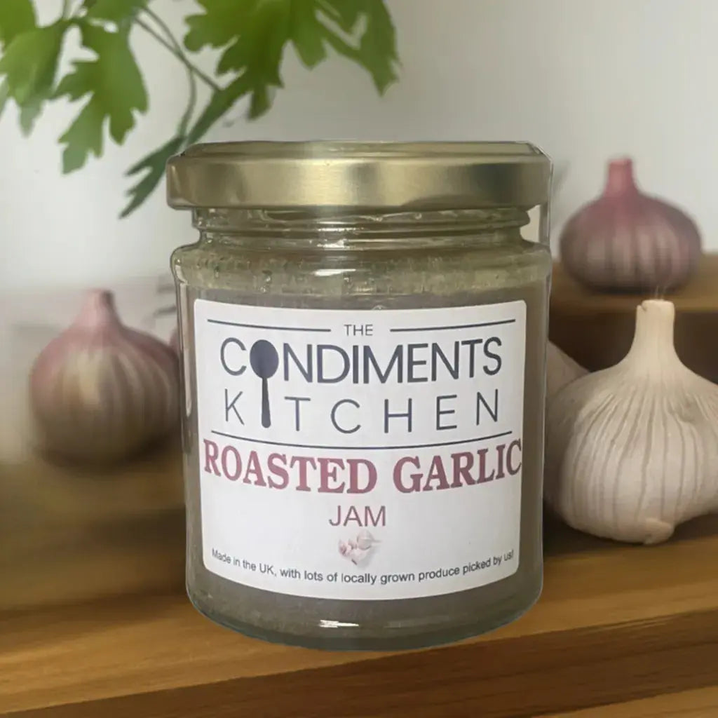 The Condiments Kitchen Roasted Garlic Jam 195g jar with roasted garlic chunks visible, ideal for chutney and relish.