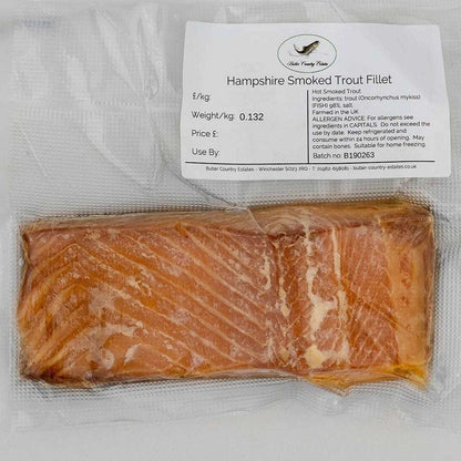 Smoked trout fillets from Hampshire, displayed on a plate with lemon and herbs, by Butler Country Estates.