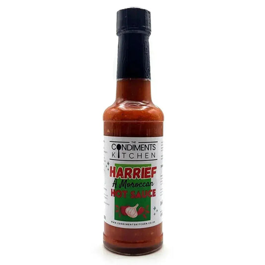 Harrief Hot Sauce by The Condiments Kitchen bottle with label, vibrant red hot sauce inside, ready for flavoring dishes