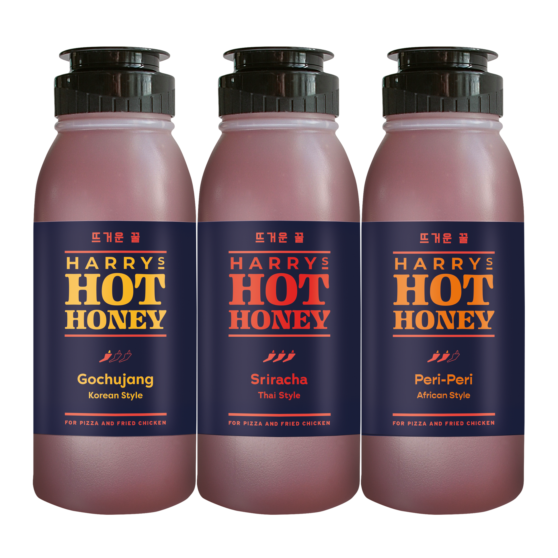 Three Harry's Hot Honey Fusion sauces in gochujang, sriracha, and Thai flavors in glass bottles with colorful labels.