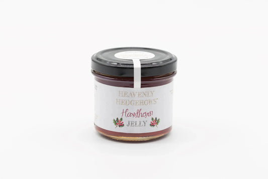 Heavenly Hedgerows Hawthorn Jelly jar with a label, showcasing the rich, deep red color of the jam in a glass jar.