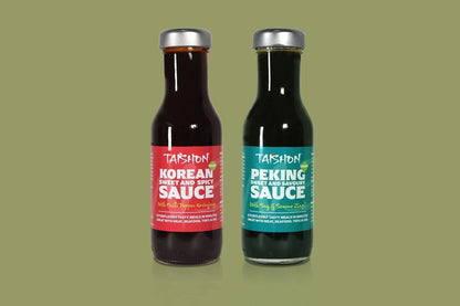 Taishon vegan Peking and Korean sauce twin pack with condiment bottles on sage background, perfect for Asian-inspired dishes.