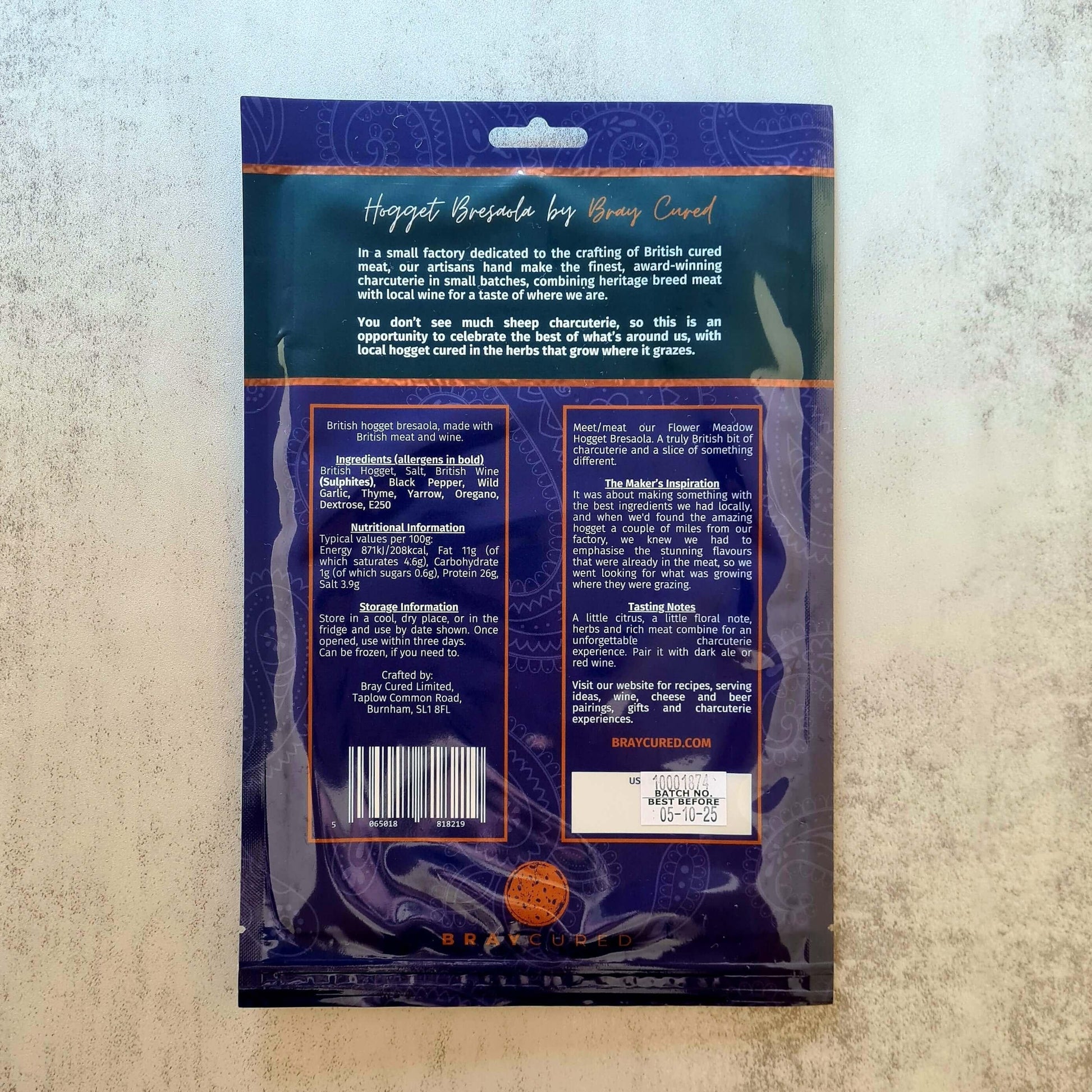 Back view of Bray Cured Hogget Bresaola charcuterie pack showing sliced dried cured lamb meat on a wooden board.