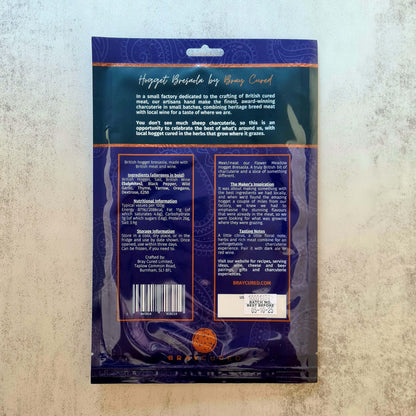Back view of Bray Cured Hogget Bresaola charcuterie pack showing sliced dried cured lamb meat on a wooden board.