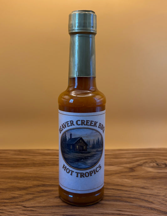 Beaver Creek BBQ Hot Tropics hot sauce bottle featuring tropical pineapple, mango, and habanero peppers for bold flavor.
