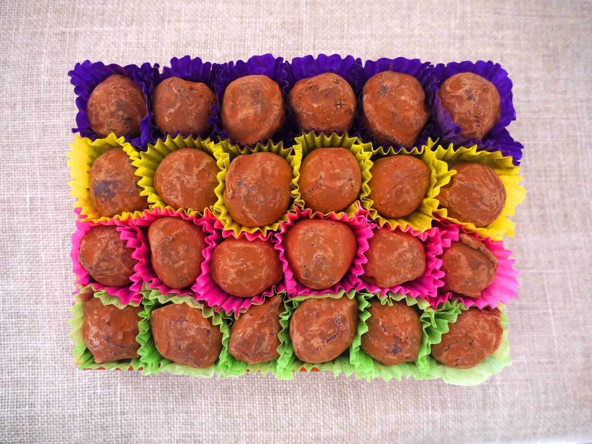 Gorvett & Stone dark chocolate house truffles arranged on a plate, showcasing smooth, rich chocolate with detailed house shapes.