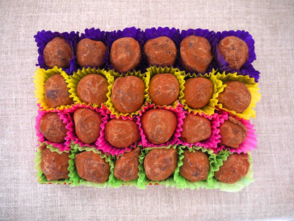 Gorvett & Stone dark chocolate house truffles arranged on a plate, showcasing smooth, rich chocolate with detailed house shapes.