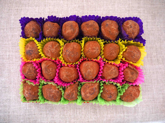 Gorvett & Stone dark chocolate house truffles arranged on a plate, showcasing smooth, rich chocolate with detailed house shapes.