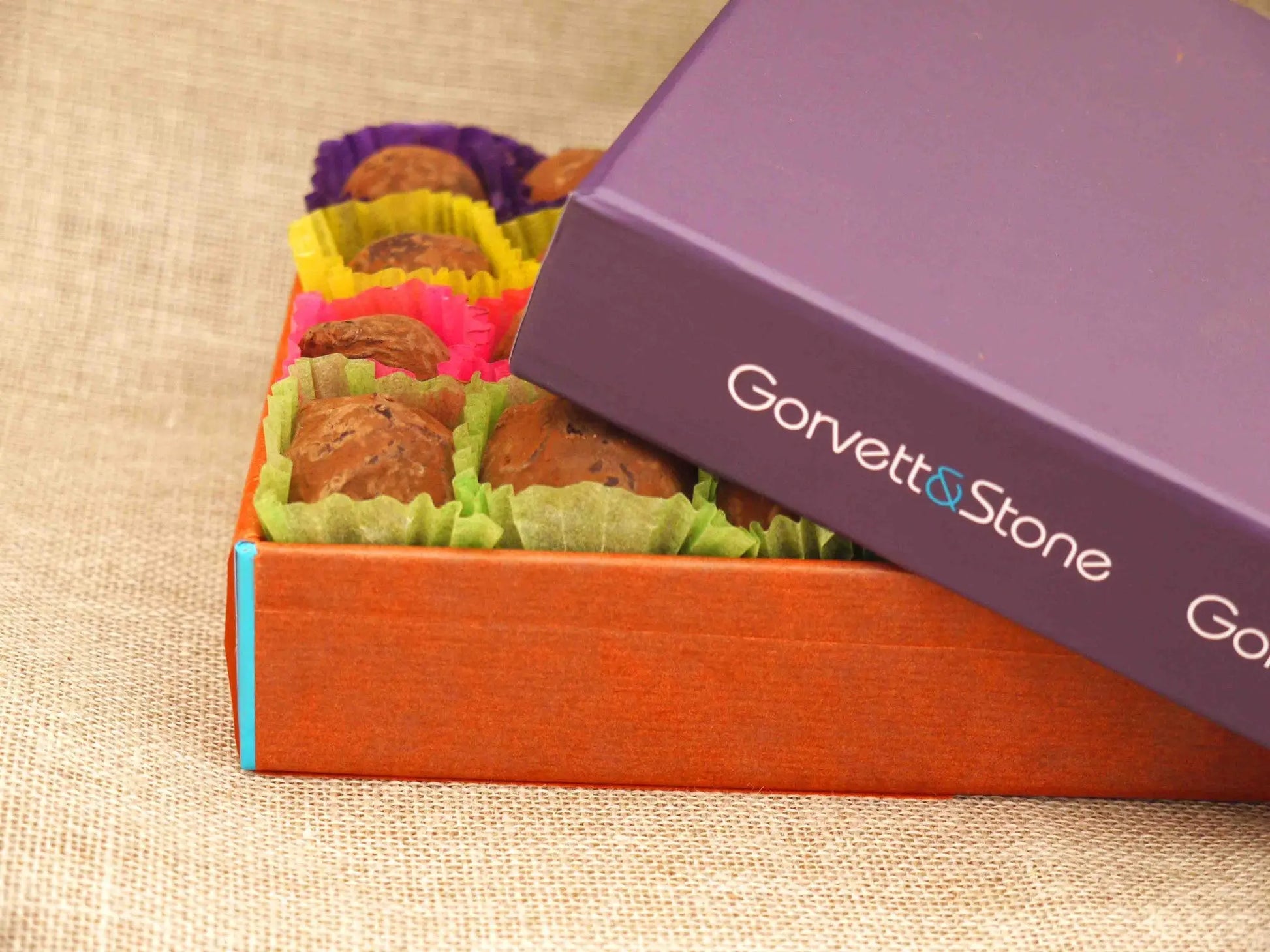 Box of Gorvett & Stone dark chocolate house-shaped truffles on a white background.