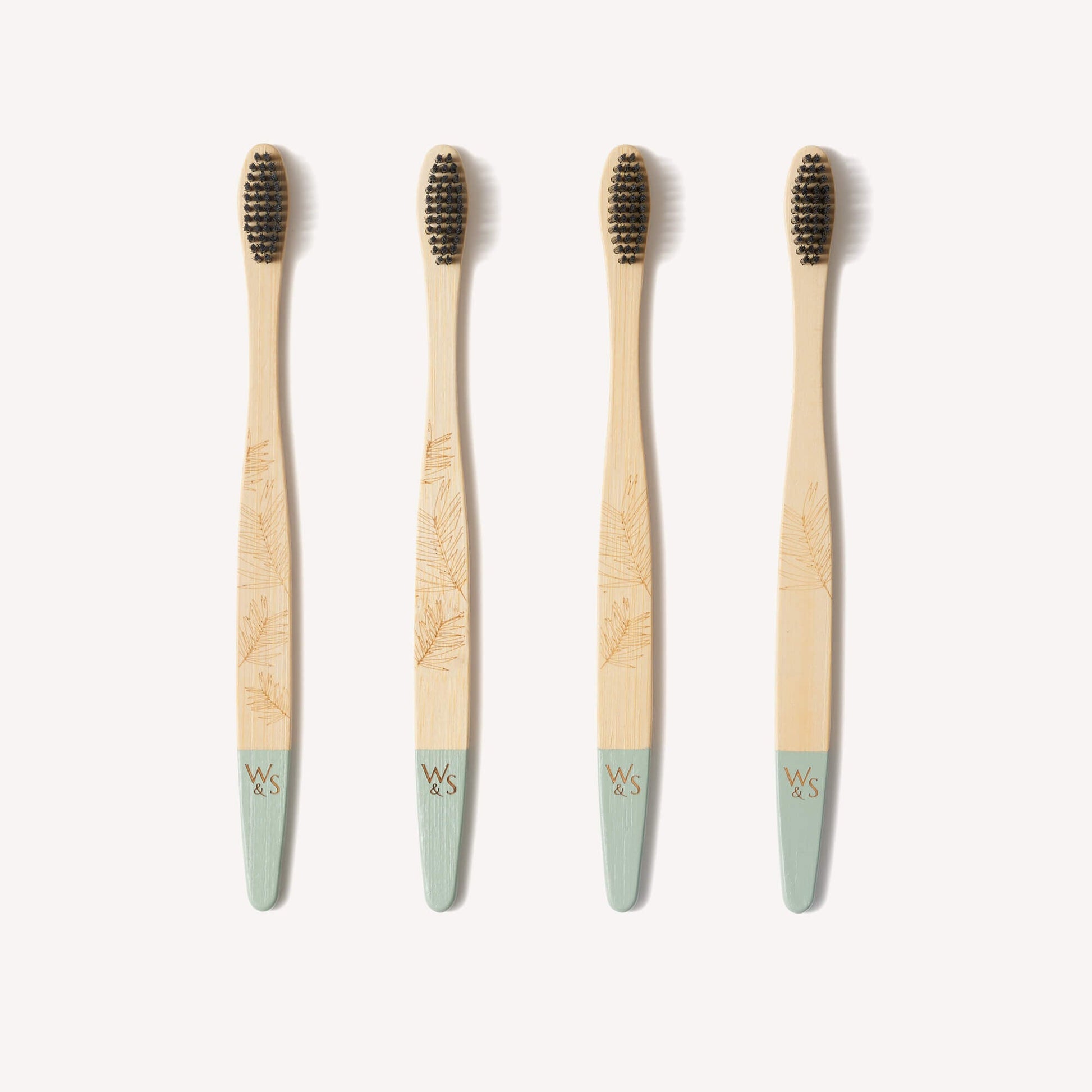 Wild and Stone adult bamboo toothbrushes with medium bristles in a 4-pack, showcasing eco-friendly toothbrushes with natural bamboo handles.