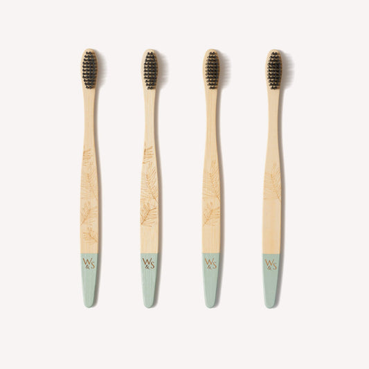 Wild and Stone adult bamboo toothbrushes with medium bristles in a 4-pack, showcasing eco-friendly toothbrushes with natural bamboo handles.