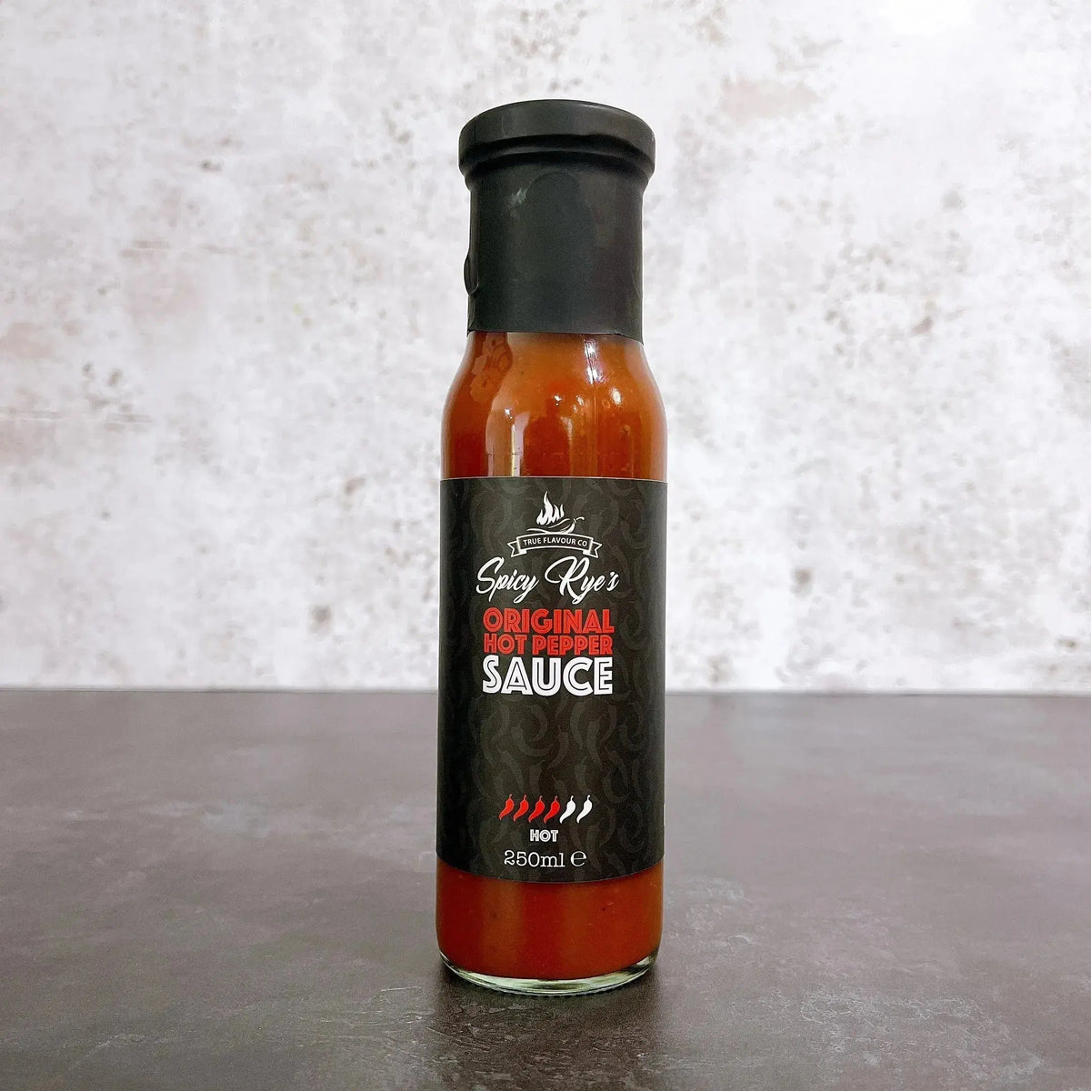 Spicy Ryes Original Hot Pepper Sauce bottle with red hot pepper and label, showcasing the spicy hot sauce product.