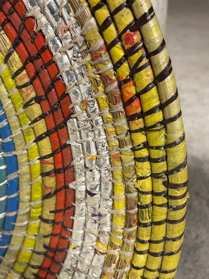 Zambian Botanical Boys wall basket with woven design, natural fibers, and decorative patterns suitable for wall decor.