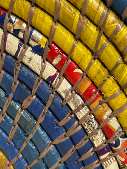 Zambian Botanical Boys wall basket with intricate woven design hanging on a wall, showcasing traditional craftsmanship.