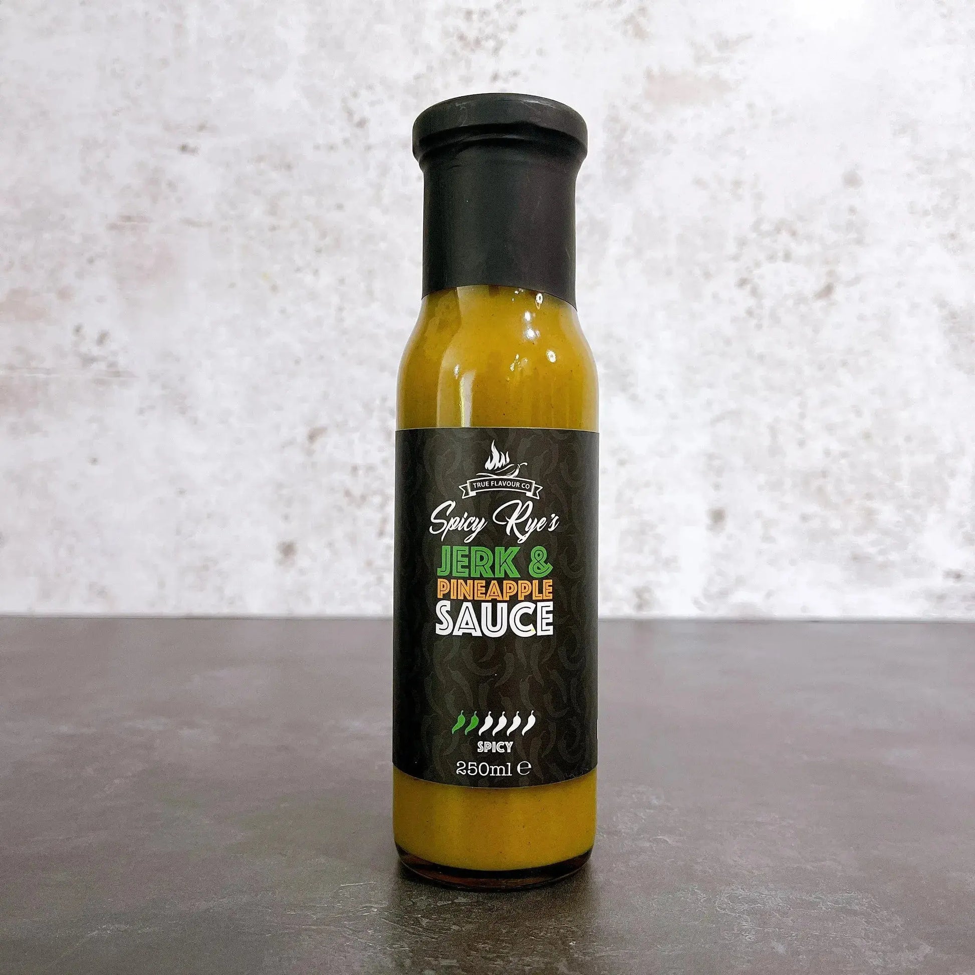 Spicy Ryes Jerk and Pineapple Hot Sauce bottle with vibrant label, showcasing a fiery sauce ideal for grilling and flavor enhancement.