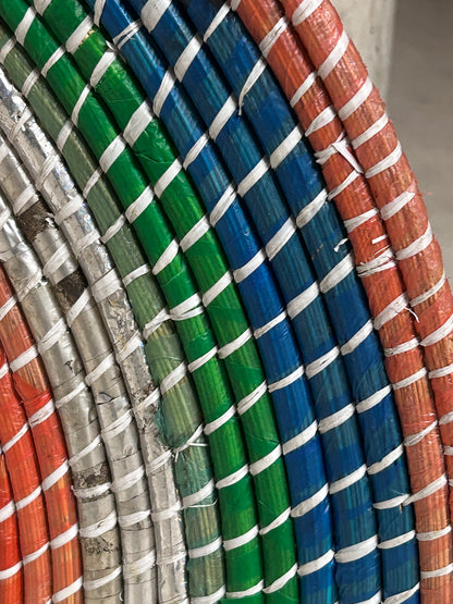 Zambian Botanical Boys wall basket made of woven natural fibers, featuring a circular design and earthy tones for wall decor.