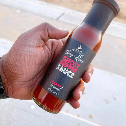 Spicy Ryes Ghost Pepper Hot Sauce bottle with fiery red sauce visible, featuring a label with ghost pepper imagery.