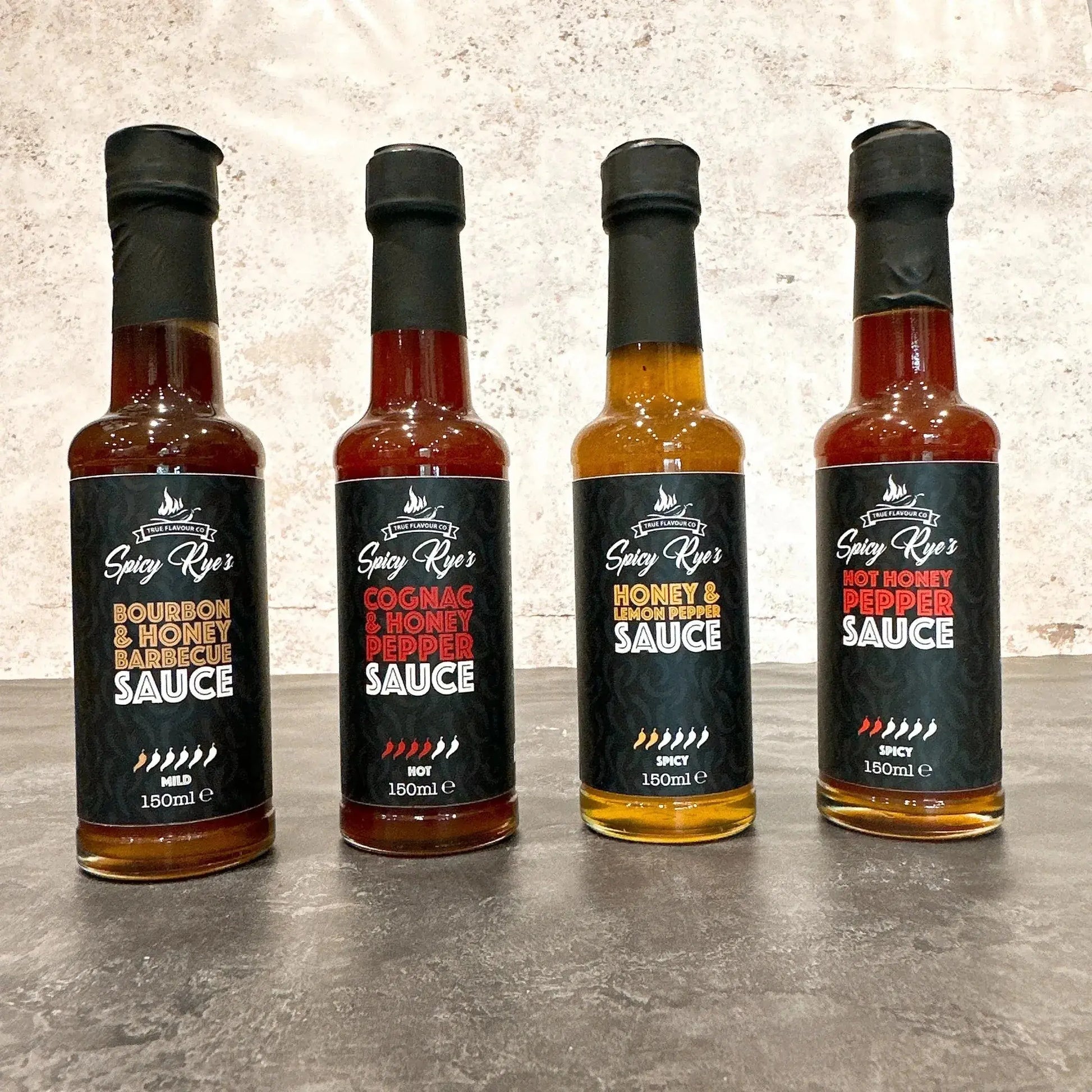 Spicy Ryes Sweet Heat Collection gift set with assorted spicy sauces and condiments in colorful packaging on a wooden table