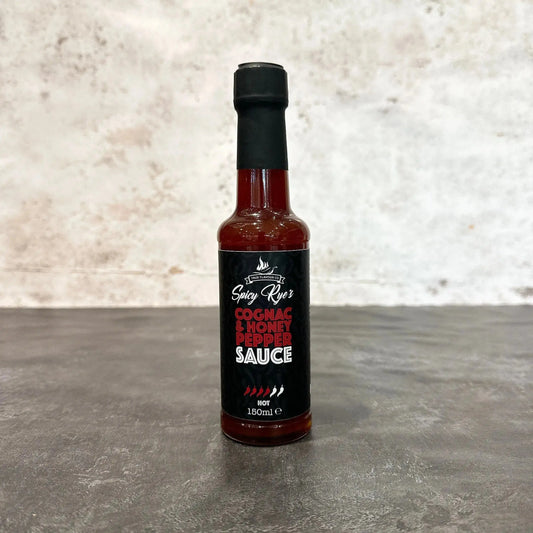 Spicy Ryes Cognac & Honey Pepper Sauce bottle, marinades and grilling sauce with rich amber color and pepper chunks visible.
