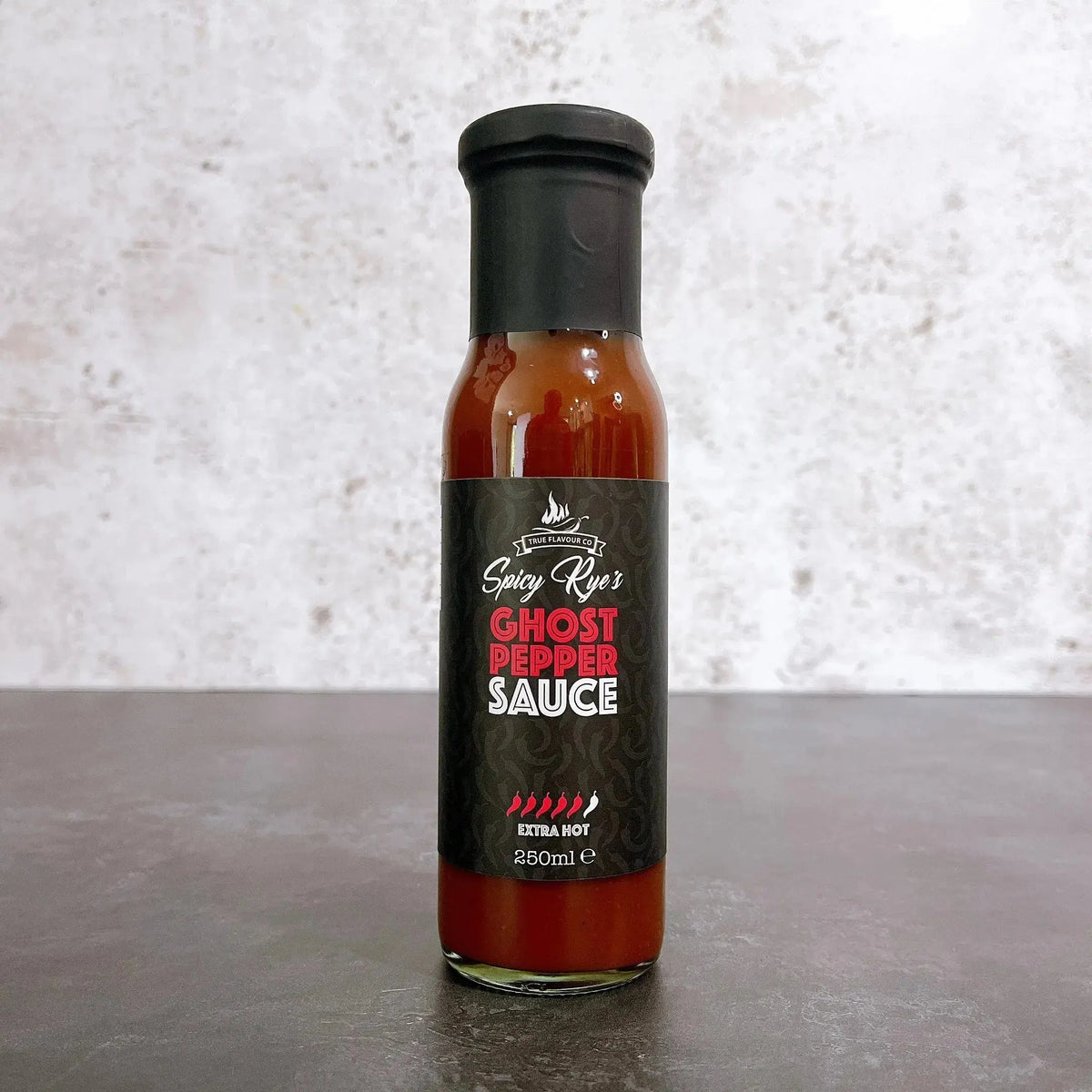 Spicy Ryes Ghost Pepper Hot Sauce bottle with vibrant label, showcasing fiery peppers and bold branding.