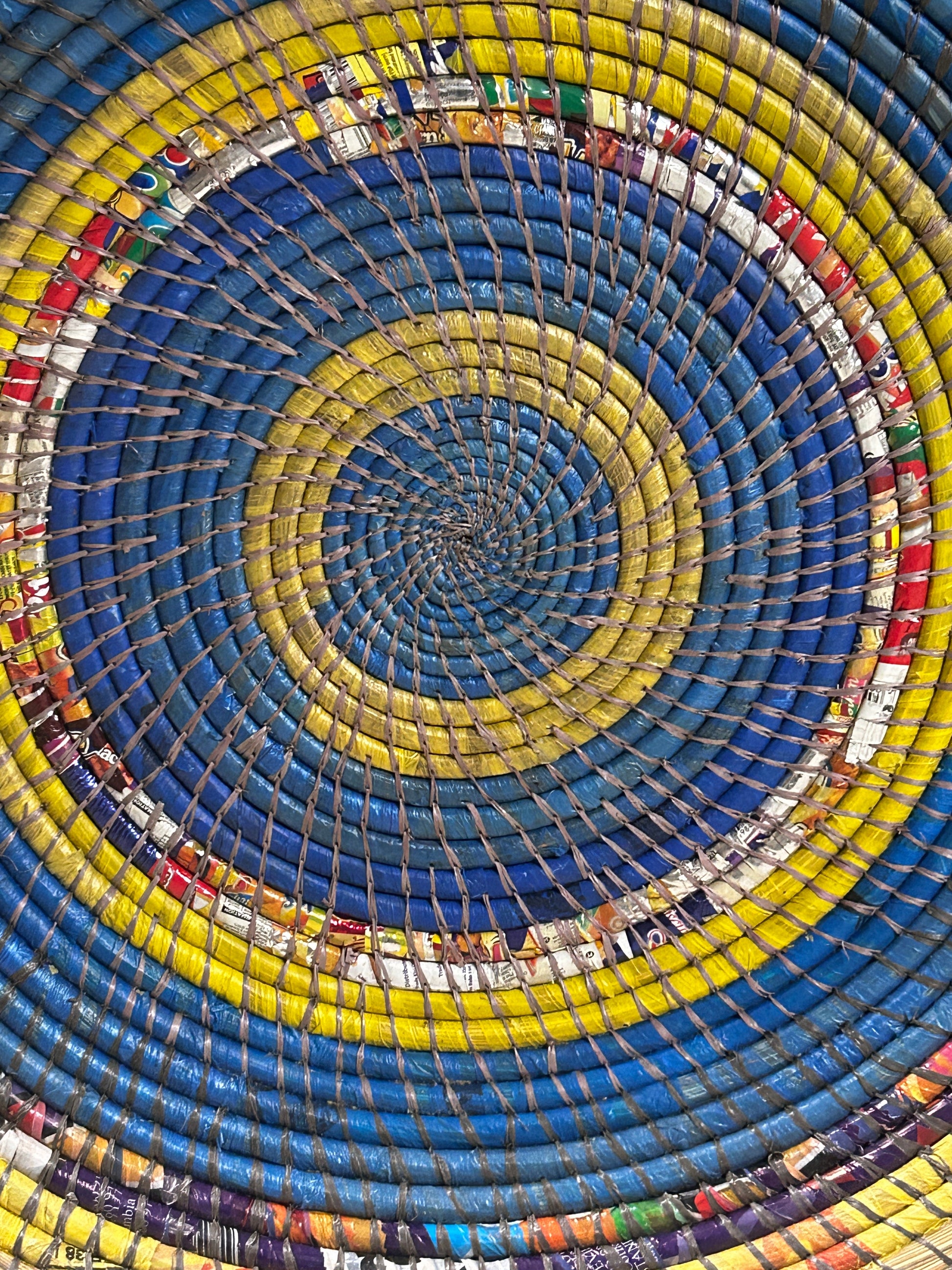 Zambian Wall Basket by Botanical Boys, woven basket with natural fibers, hanging on a wall for decorative storage or display.