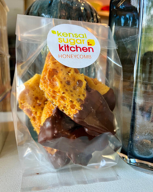 Chocolate dipped honeycomb by Kensal Sugar Kitchen, showing golden honeycomb coated in rich chocolate on a white background.
