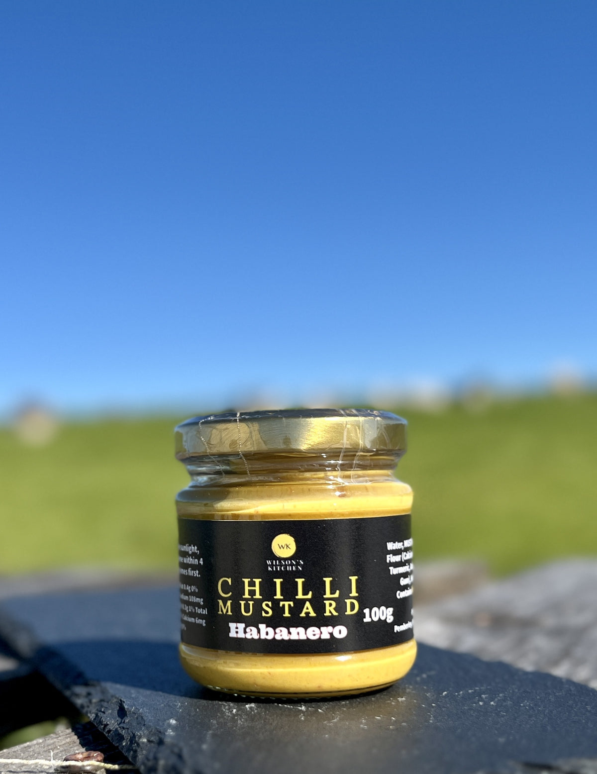 Wilson’s Kitchen Habanero Chilli Mustard jar, spicy cooking ingredient with bright yellow mustard and fiery habanero peppers.