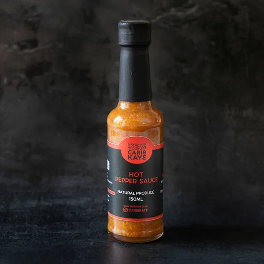 CaribKaye Hot Pepper Sauce bottle with bright red hot sauce, featuring a label and cap, on a neutral background.