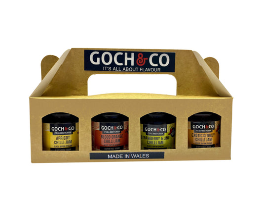 Goch & Co Goch Chilli Jams Gift Set with assorted spicy chili jams in glass jars, arranged on a wooden surface.