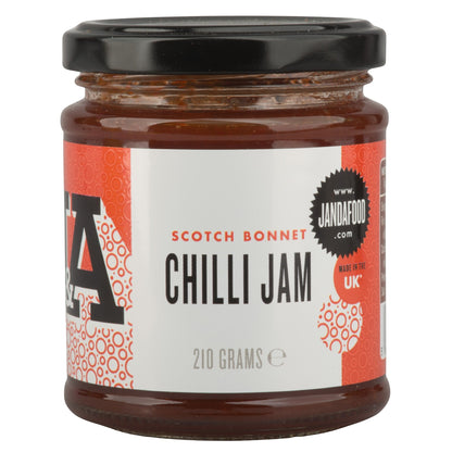 Janda Scotch Bonnet Chilli Jam 210g jar with red chili peppers and a spoon, showcasing spicy-sweet chilli jam for cheese and barbecue.