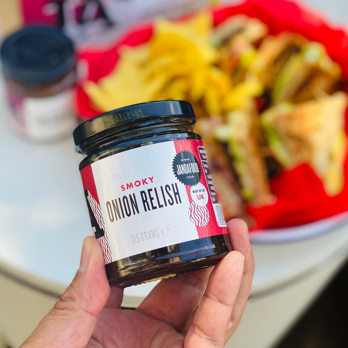 Janda Food Smoky Onion Relish jar with dark, caramelized onions and smoky glaze, ideal as a gourmet cheese condiment.