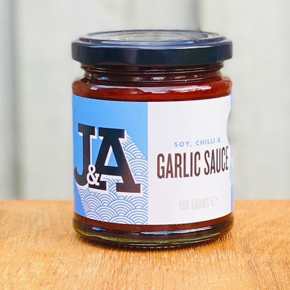Janda Soy, Chilli & Garlic Sauce bottle with label, showcasing the rich, spicy sauce inside a clear glass jar.