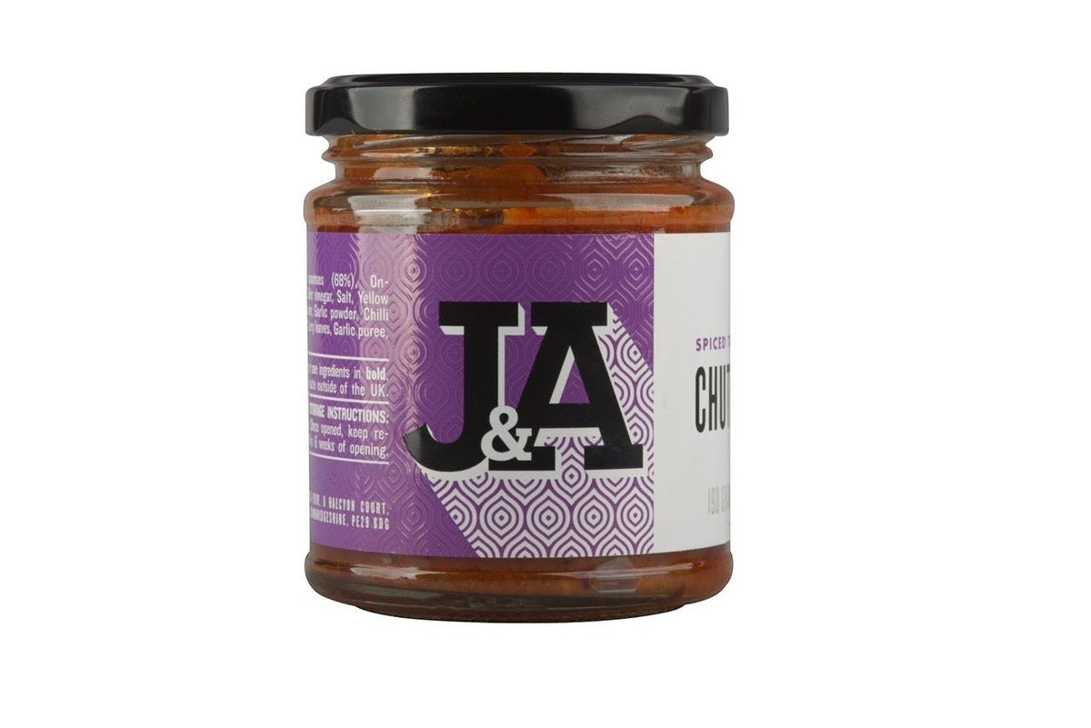 Jar of Janda spiced tomato chutney with vibrant red color, showcasing the rich, chunky texture and fresh ingredients.