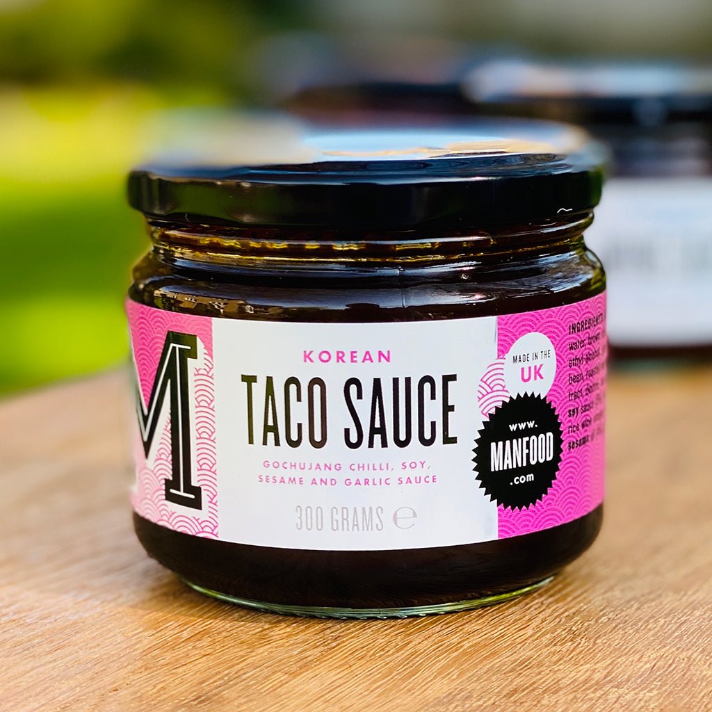 Manfood Korean Taco Sauce bottle with label and cap, showcasing the spicy, flavorful sauce in a clear glass jar.
