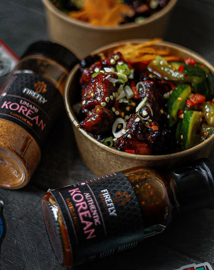 Spicy Korean BBQ sauce by FireFly Barbecue in a glass jar, showing rich, dark reddish-brown sauce with a glossy texture.