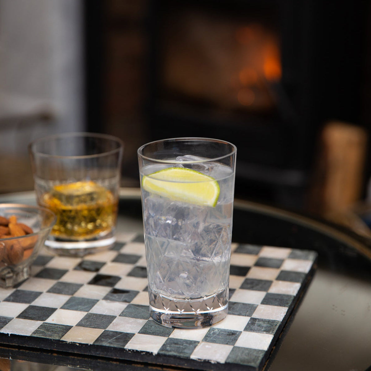 Crystal highball glass with a lattice design by The Vintage List, showcasing intricate cut patterns for elegant drink presentation.