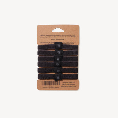 Six black plastic-free hair ties from Wild And Stone, made of eco-friendly material, shown in a 6-pack on a neutral background.