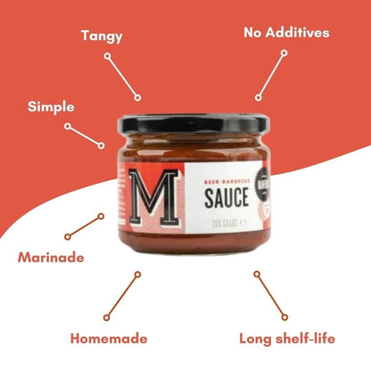 Manfood Beer Barbecue Sauce bottle with label, showcasing rich, dark sauce in a squeeze bottle on a wooden surface.