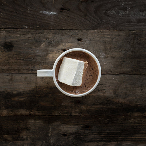 A cup of Harry's Hot Chocolate topped with marshmallows, showcasing rich hot chocolate with fluffy marshmallow toppings.