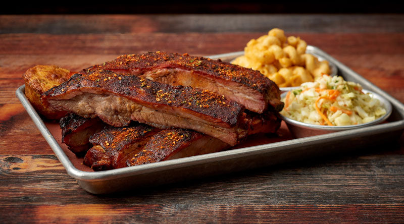 Memphis Dry Savoury BBQ Rub by FireFly Barbecue on pork spare ribs, showcasing a seasoned, smoky meat ready for grilling.
