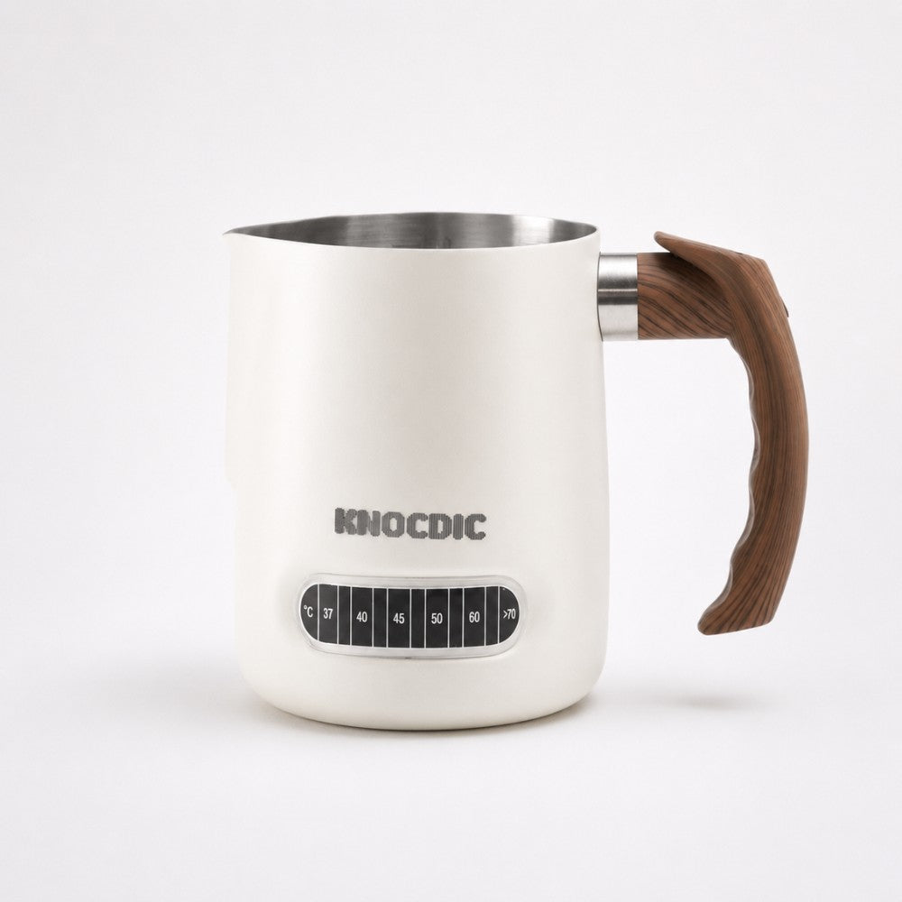 KNOCDIC® milk frothing pitcher with built-in thermometer for perfect steamed milk and latte art preparation.