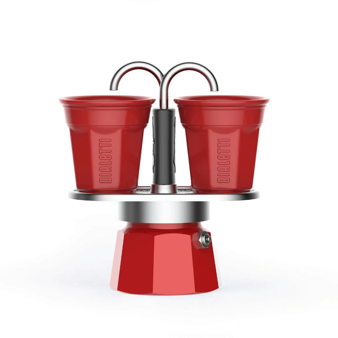 Red Bialetti Mini Express 'R' double serve espresso maker with two cups for brewing authentic Italian coffee.