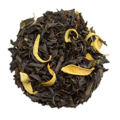 A cup of orange blossom oolong tea from PekoeTea Edinburgh with vibrant orange blossom petals and brewed tea in a clear glass cup.