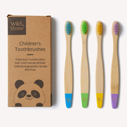 Four colorful children's bamboo toothbrushes by Wild and Stone, eco-friendly and designed for gentle brushing.