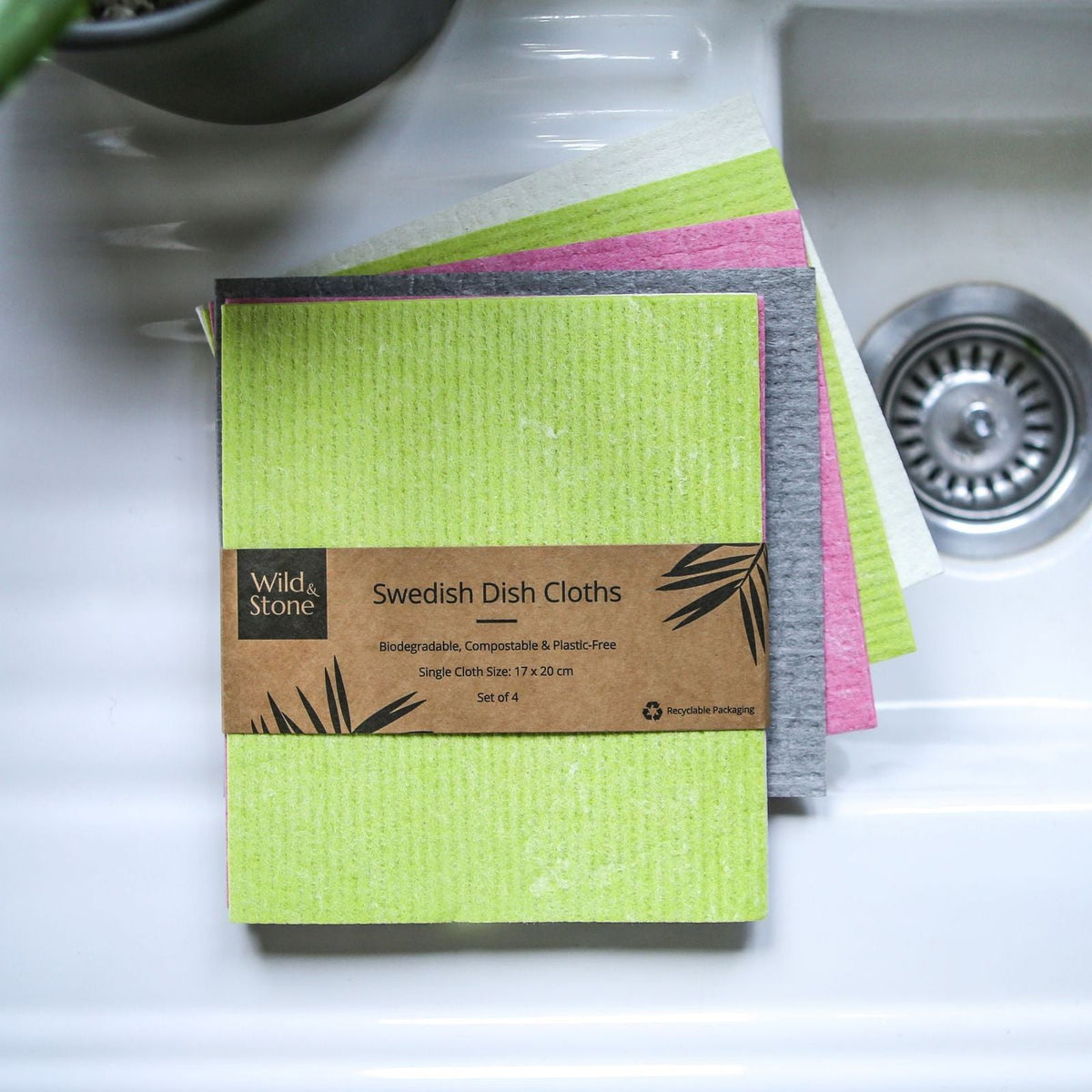 Set of four Wild And Stone compostable Swedish dish cloths with colorful, absorbent fabric on a clean kitchen surface.