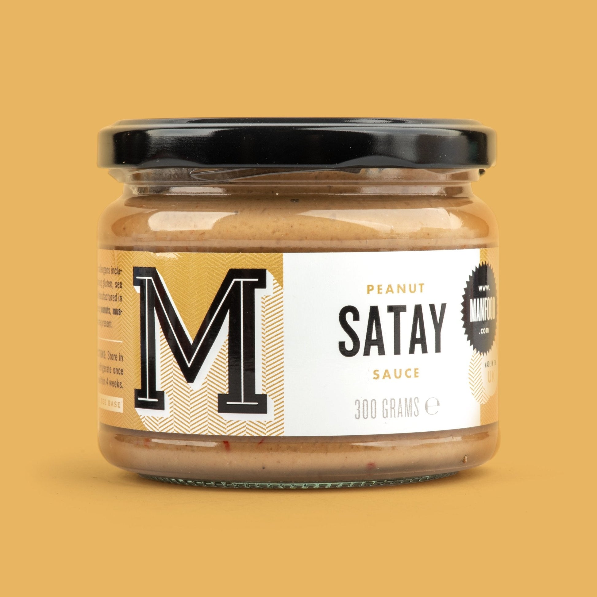 Creamy peanut satay sauce in a bowl, featuring rich peanut and spice flavors, by Manfood.