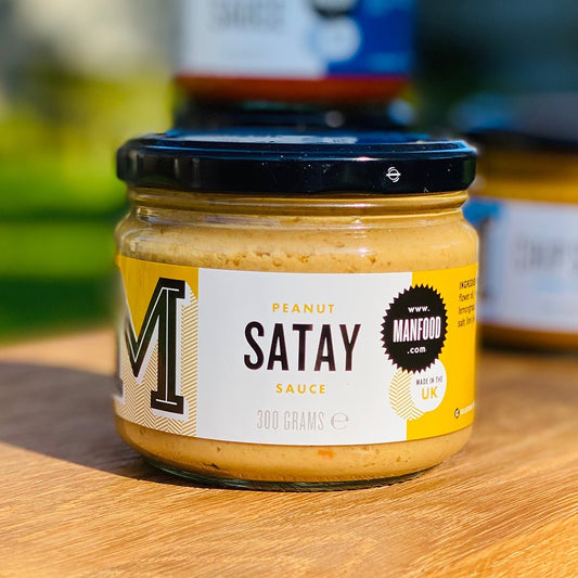 Creamy peanut satay sauce by Manfood in a glass jar, showing a smooth, rich texture perfect for dipping or cooking.