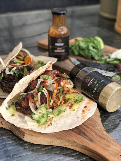 Italian Porchetta Rub barbecue seasoning by FireFly Barbecue, showing a close-up of the flavorful spice blend in a jar.